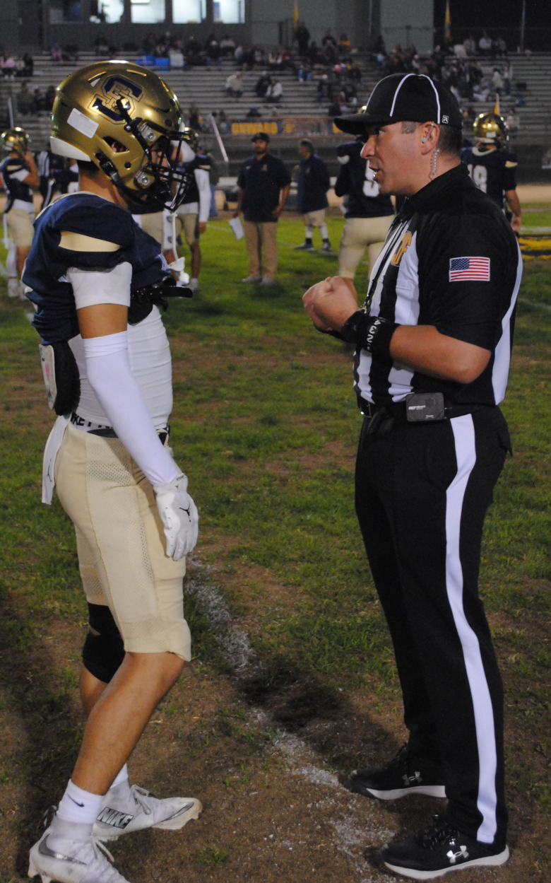 Corey McManimen meets with a player pre-game to discuss points of emphasis prior to a CIF-SS playoff game.