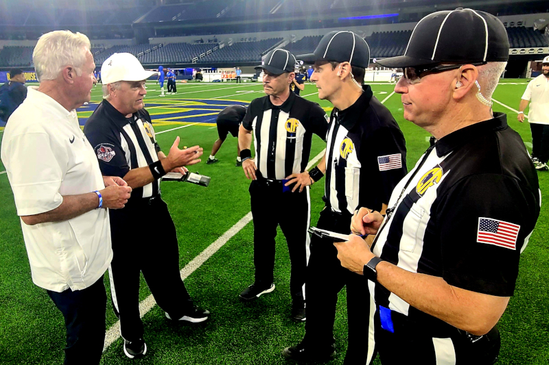 White Hat Kyle Cason and crew members discuss key points of emphasis pre-game at SoFi Stadium
